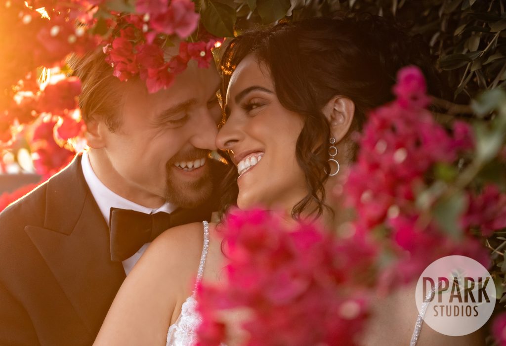 Villa De Amore garden ceremony with burgundy and gold floral arch