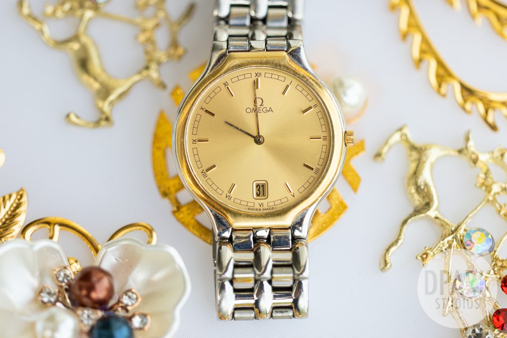 Groom wearing Omega watch holding bride’s hand at Gold Coast Farms sunflower wedding by D. Park Studios