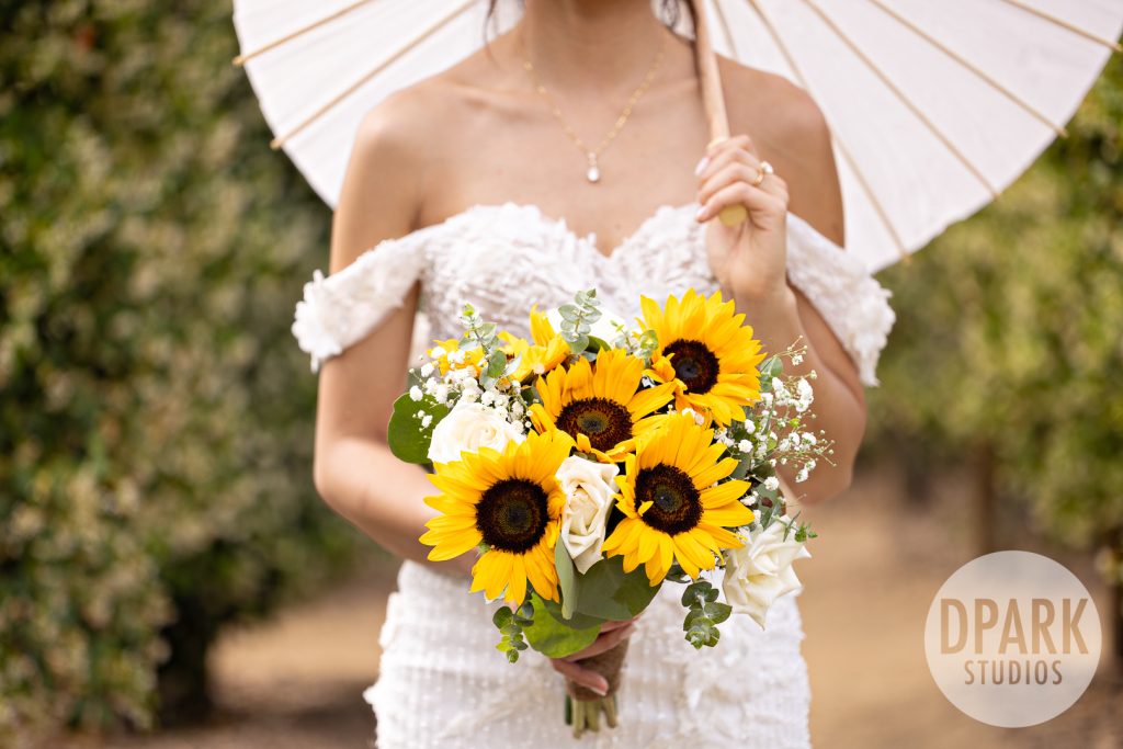 Whimsical sunflower table decor by Daisy’s Flowers for OC farm wedding reception
