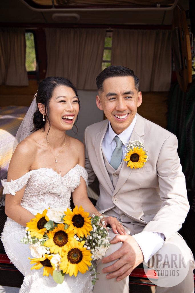 Couple laughing with officiant Raul Arrieta during vows at sunflower ceremony
