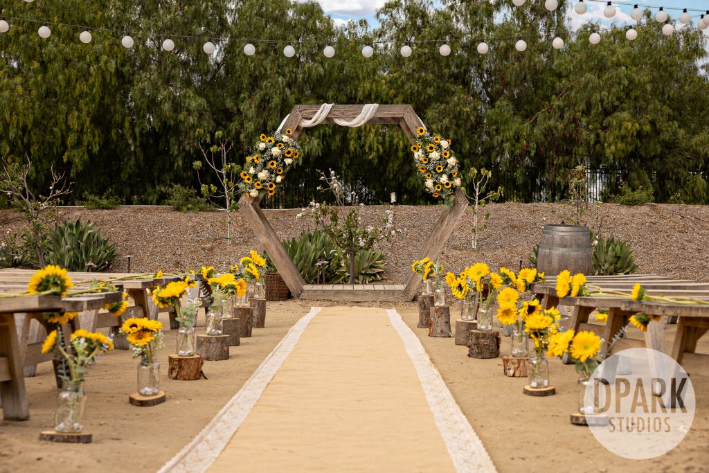 Bride and groom sneaking a kiss during Chinese tea ceremony by D. Park Studios at Gold Coast Farms