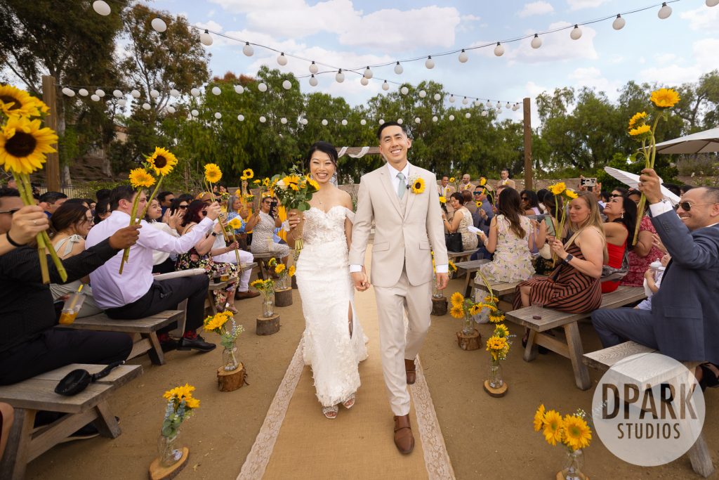 Bride holding sunflower bouquet by Daisy’s Flowers with e2Beauty hair and makeup at Gold Coast Farms