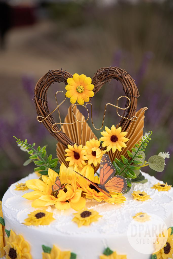 Reception details with Grace Catering plates and sunflower centerpieces at Gold Coast Farms
