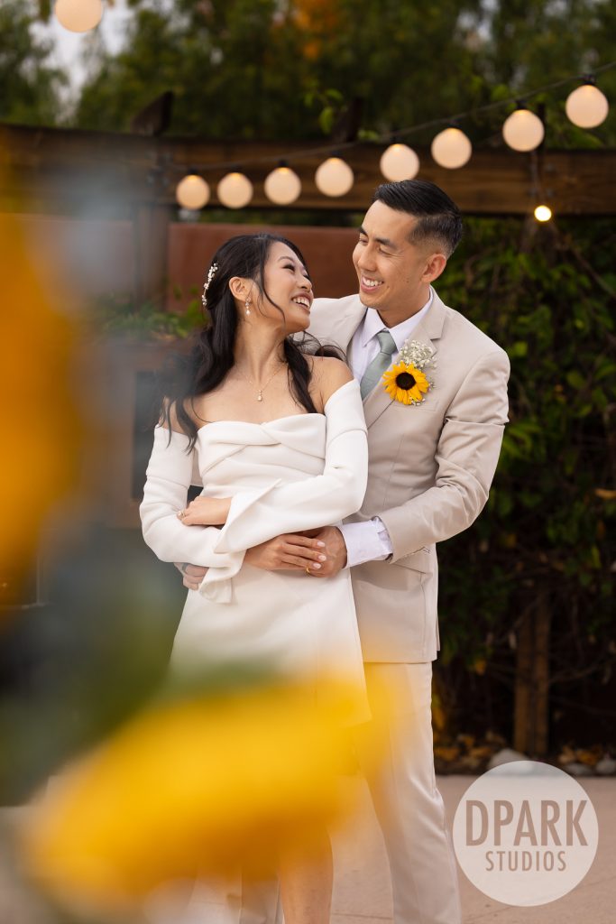 Bride’s Omega watch and engagement ring close up at whimsical sunflower wedding