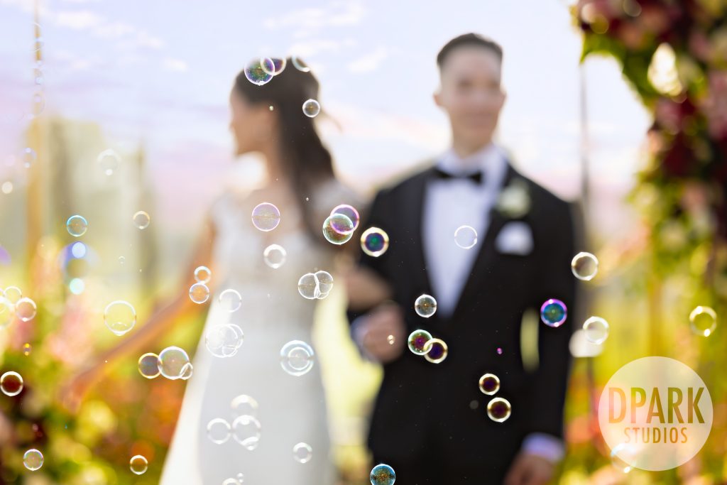 Bride and groom toasting guests during VEA Newport Beach wedding reception