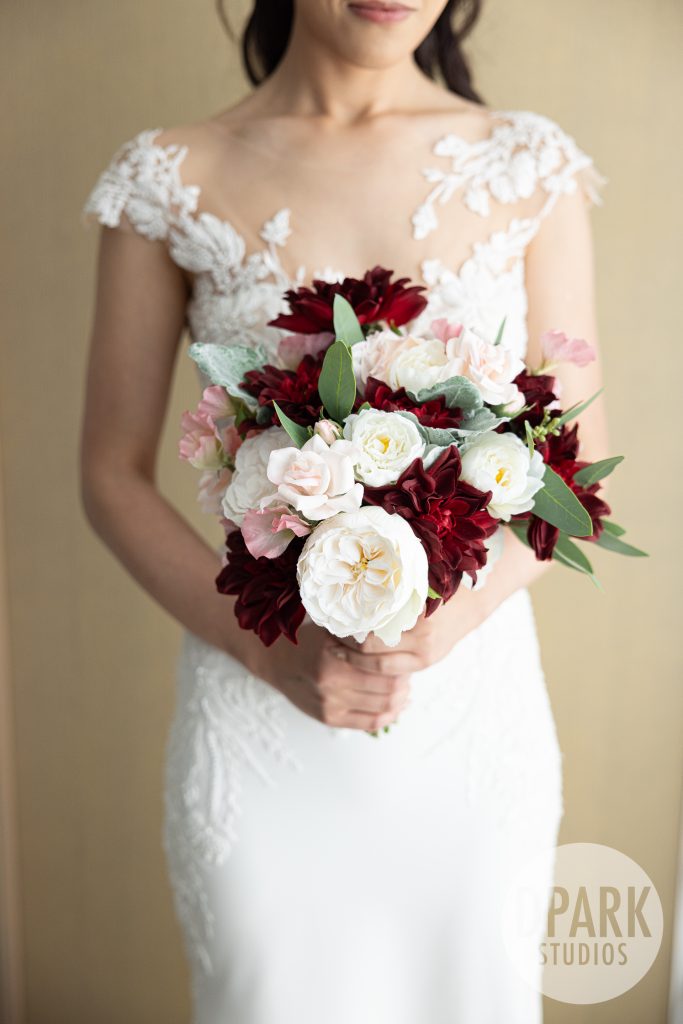 Elegant black, red, and gold wedding ceremony at VEA Newport Beach resort