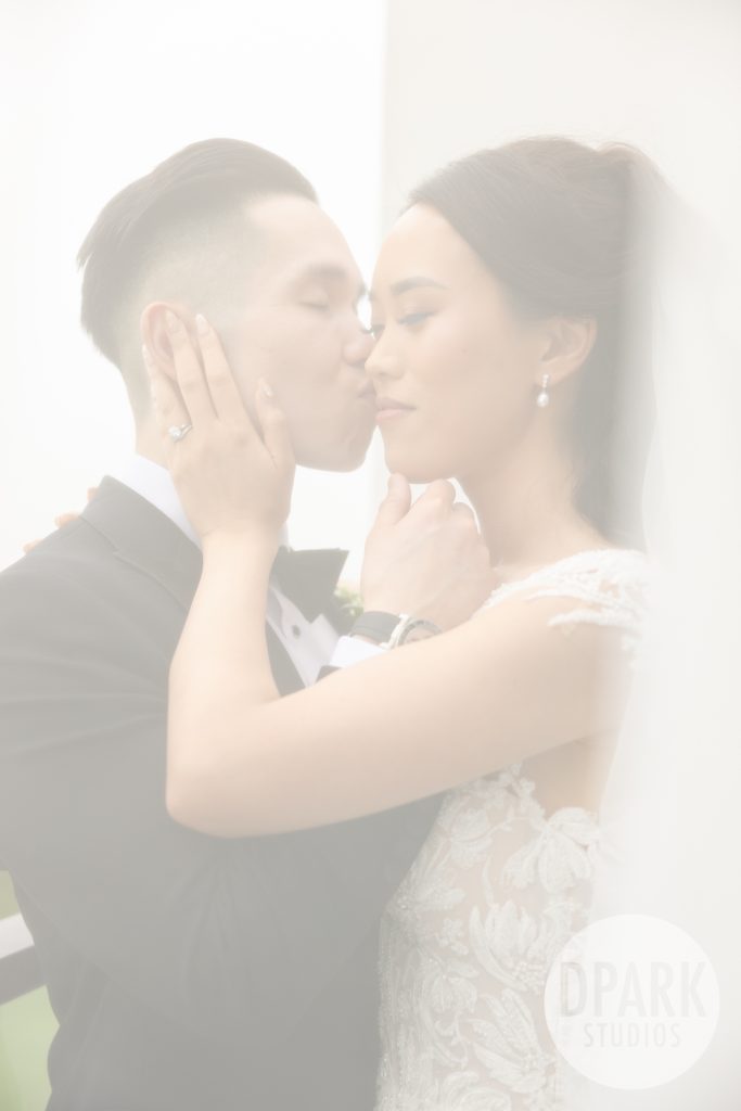 Bride and groom laughing during vows at elegant VEA Newport wedding