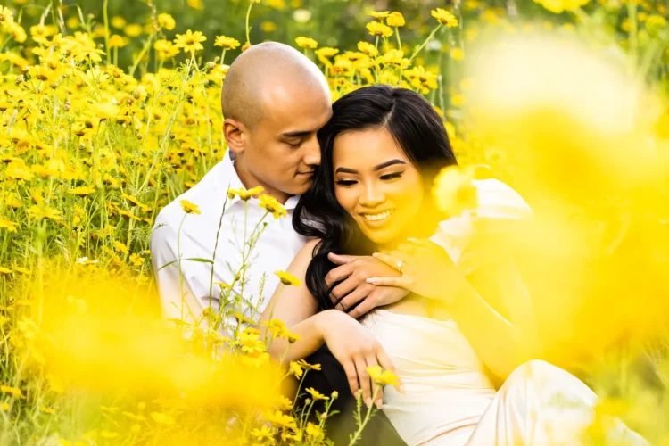Twilight inspired Vietnamese bride and hapa groom hold each other in yellow flower field during super bloom at Canyon Park