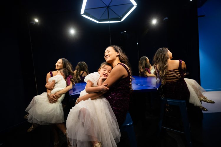 mother daughter adorable hug maternity family photo at illusions museum