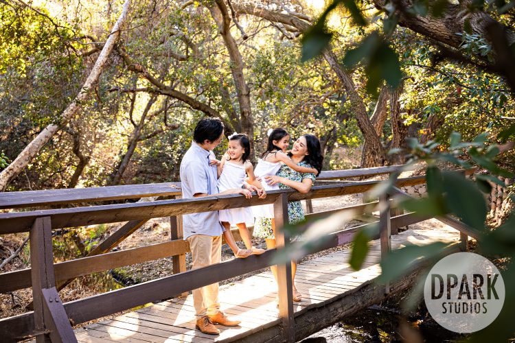 Le Family with two young daughters during a sunset family photography session at Oak Canyon Nature Center in Anaheim Hills
